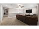 Loft living room offering a view, neutral carpet, and TV at 8609 Winning Fields Rd, New Port Richey, FL 34655