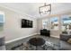Cozy living room with natural light, a piano, and stylish decor at 8609 Winning Fields Rd, New Port Richey, FL 34655