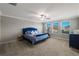 Spacious main bedroom boasting natural light, carpet, and ceiling fan at 8609 Winning Fields Rd, New Port Richey, FL 34655