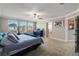 Main bedroom with carpeted floors, ceiling fan, and adjoining bathroom at 8609 Winning Fields Rd, New Port Richey, FL 34655