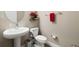 Powder room featuring sleek, modern toilet and sink, plus neutral paint at 8609 Winning Fields Rd, New Port Richey, FL 34655