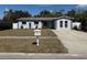 Charming single-story home with a well-maintained lawn, a welcoming mailbox, and an inviting front entrance with a pale-blue door at 11803 127Th Ave, Largo, FL 33778