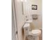 Small half bath with pedestal sink, neutral walls, and framed picture above toilet at 11803 127Th Ave, Largo, FL 33778