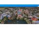 Aerial view of a residential area with a picturesque lake and lush greenery at 1032 Jambalana Dr, Holiday, FL 34691