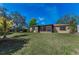 Spacious backyard with a screened-in patio and lush green lawn at 1032 Jambalana Dr, Holiday, FL 34691