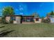 Spacious backyard with a screened patio, offering ample room for outdoor activities at 1032 Jambalana Dr, Holiday, FL 34691