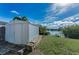 Backyard storage shed with brick base and views of the lake at 1032 Jambalana Dr, Holiday, FL 34691
