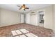 Spacious bedroom with a ceiling fan, plush carpet, and multiple entryways at 1032 Jambalana Dr, Holiday, FL 34691