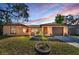 Charming single-story home featuring a well-maintained lawn, neutral stucco, and a cozy, inviting facade at 1032 Jambalana Dr, Holiday, FL 34691
