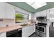 Well-equipped kitchen with stainless steel appliances and tiled backsplash at 1032 Jambalana Dr, Holiday, FL 34691