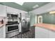 Modern kitchen with stainless steel refrigerator and oven, plus ample cabinet space at 1032 Jambalana Dr, Holiday, FL 34691