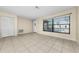 Bright living room with tile flooring and a large window providing ample natural light at 1032 Jambalana Dr, Holiday, FL 34691
