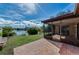 Lovely brick patio looks out onto grassy lawn and beautiful lake view at 1032 Jambalana Dr, Holiday, FL 34691