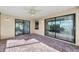 Covered patio with brick flooring and sliding glass doors offers a relaxing outdoor space at 1032 Jambalana Dr, Holiday, FL 34691