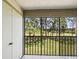 Enjoy the view from this screened balcony overlooking a manicured lawn and mature trees at 106 Meadow Ln # 106, Oldsmar, FL 34677