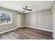 A cozy bedroom featuring new flooring, neutral colors, and a sunlit window at 106 Meadow Ln # 106, Oldsmar, FL 34677