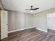 Spacious bedroom featuring new flooring, neutral colors, and a closet with louvered door at 106 Meadow Ln # 106, Oldsmar, FL 34677