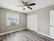 Bright bedroom with ceiling fan, modern flooring, and closet for ample storage at 106 Meadow Ln # 106, Oldsmar, FL 34677