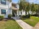 Charming condo building with lush landscaping and mature trees at 106 Meadow Ln # 106, Oldsmar, FL 34677