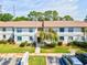 Aerial view of a condo community with ample parking and mature trees at 106 Meadow Ln # 106, Oldsmar, FL 34677