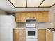 Kitchen features white appliances, a light colored countertop, and cabinets for ample storage at 106 Meadow Ln # 106, Oldsmar, FL 34677