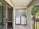 The covered balcony offers in-unit laundry, with tile floor, and extra storage at 106 Meadow Ln # 106, Oldsmar, FL 34677