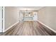 Open living area view towards kitchen with gray walls, wood floors, and a modern chandelier at 106 Meadow Ln # 106, Oldsmar, FL 34677