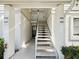 Well-maintained condo building with freshly painted staircase and mature landscaping at 106 Meadow Ln # 106, Oldsmar, FL 34677