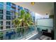 Relaxing balcony with comfortable seating and a view of lush greenery and a nearby building at 111 N 12Th St # 1426, Tampa, FL 33602