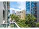 Balcony view showcasing nearby buildings and lush green trees in a vibrant urban setting at 111 N 12Th St # 1426, Tampa, FL 33602
