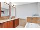 Bright bathroom with double sink vanity, framed mirrors, tiled backsplash, and a relaxing soaking tub at 111 N 12Th St # 1426, Tampa, FL 33602
