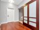 Hallway with hardwood floors, sliding closet doors, and a view to the bedroom at 111 N 12Th St # 1426, Tampa, FL 33602