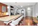 Bright kitchen with granite countertop island, stainless steel appliances, hardwood floors, and bar seating at 111 N 12Th St # 1426, Tampa, FL 33602