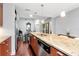 Modern kitchen features a granite countertop island with stainless steel appliances and hardwood floors at 111 N 12Th St # 1426, Tampa, FL 33602