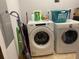 Laundry room with a white washer and dryer, shelving, and cleaning supplies at 111 N 12Th St # 1426, Tampa, FL 33602