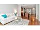 Cozy living room with hardwood floors, a plush white sofa, and an open view to the kitchen at 111 N 12Th St # 1426, Tampa, FL 33602
