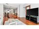 Comfortable living room featuring hardwood floors, a modern glass coffee table, and kitchen view at 111 N 12Th St # 1426, Tampa, FL 33602