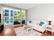 Bright living room with a sliding glass door to a private balcony with tropical landscaping views at 111 N 12Th St # 1426, Tampa, FL 33602