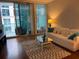 Bright living room with a glass coffee table, rug, and a balcony offering city views at 111 N 12Th St # 1426, Tampa, FL 33602