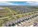 Expansive aerial view of a vibrant residential community with well-maintained homes and a scenic pond at 11301 Hudson Hills Ln, Riverview, FL 33579