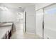 Bright bathroom featuring a glass-enclosed shower, a single sink vanity, and ceramic flooring at 11301 Hudson Hills Ln, Riverview, FL 33579