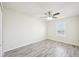 A bright bedroom showcasing the window and wood-look vinyl flooring at 11301 Hudson Hills Ln, Riverview, FL 33579