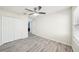 Bright bedroom with closet, ceiling fan, and modern vinyl flooring at 11301 Hudson Hills Ln, Riverview, FL 33579