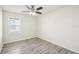 This bedroom features wood-look vinyl flooring and a bright window at 11301 Hudson Hills Ln, Riverview, FL 33579