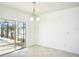 Bright dining area featuring sliding glass doors with views of the backyard pool at 11301 Hudson Hills Ln, Riverview, FL 33579