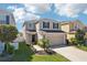Attractive two-story home featuring a manicured lawn, neat landscaping, and a convenient two-car garage at 11301 Hudson Hills Ln, Riverview, FL 33579