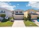 Charming two-story home featuring a two-car garage, well-manicured lawn, and inviting curb appeal at 11301 Hudson Hills Ln, Riverview, FL 33579