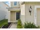 Charming front entrance featuring manicured landscaping and a dark green front door at 11301 Hudson Hills Ln, Riverview, FL 33579