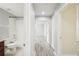Bright hallway leading to rooms with modern flooring, a bathroom and neutral wall colors at 11301 Hudson Hills Ln, Riverview, FL 33579