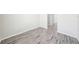 Modern vinyl floor hallway with white walls and doorways at 11301 Hudson Hills Ln, Riverview, FL 33579